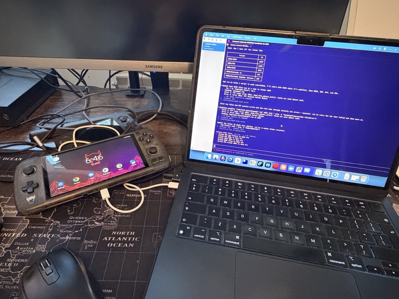 The Odin Pro plugged into the MacBook — Claude Code running the session on screen