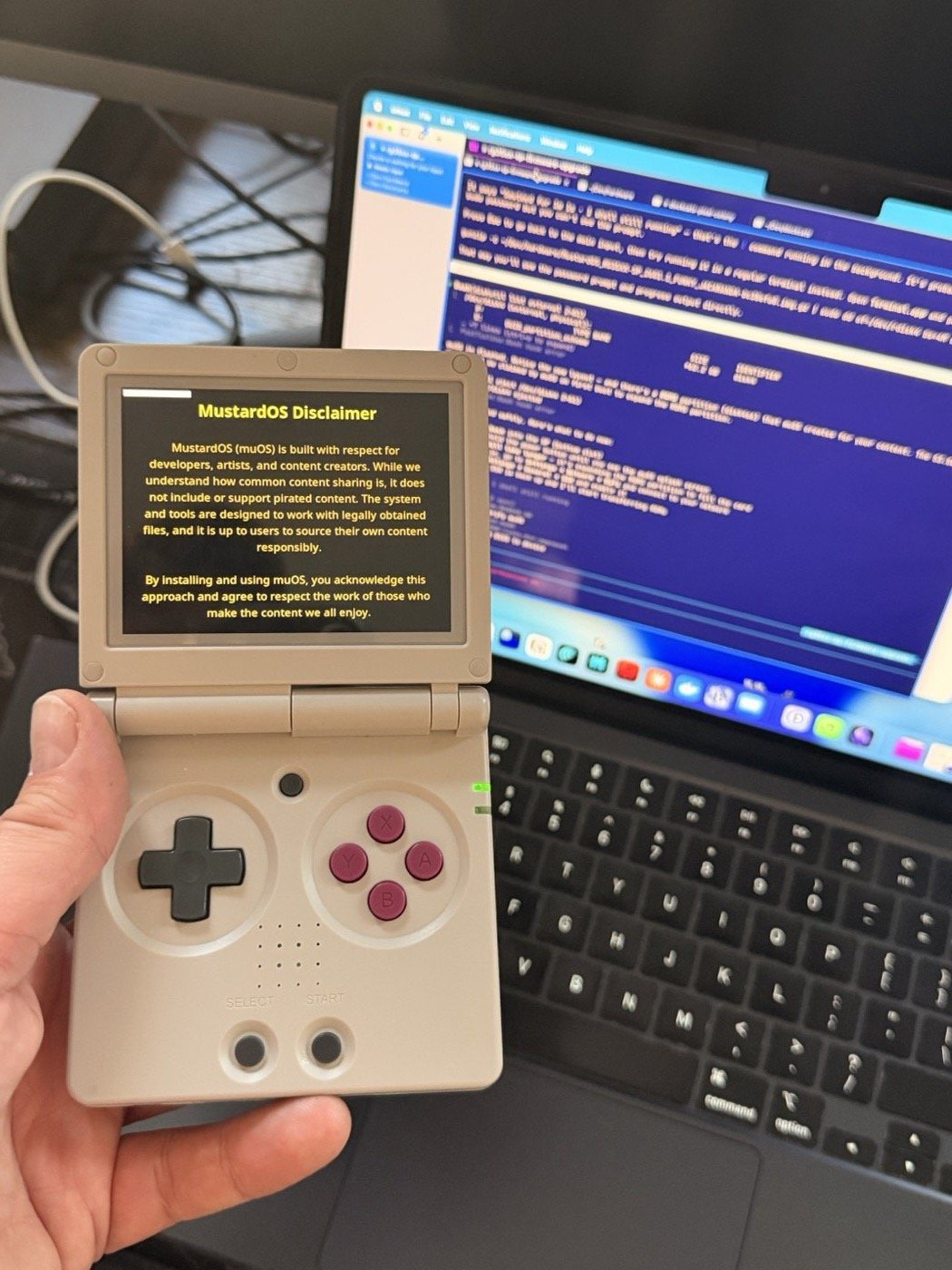 The RG35XX SP running muOS for the first time — Claude Code session visible in the background
